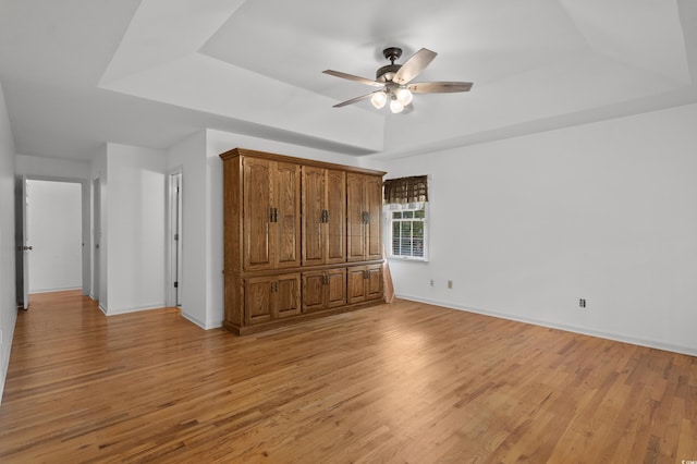 1415 Fox Hollow Way N, Myrtle Beach, SC 29582 - unfurnished bedroom with light wood finished floors, a tray ceiling, and ceiling fan