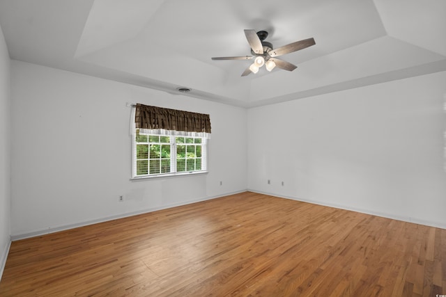 1415 Fox Hollow Way N, Myrtle Beach, SC 29582 - empty room with a raised ceiling, light wood-style flooring, and a ceiling fan