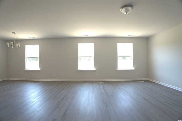 205 Kc Ln, Aynor, SC 29511 - spare room with a chandelier, plenty of natural light, and dark wood-type flooring