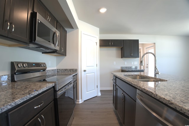 205 Kc Ln, Aynor, SC 29511 - kitchen with appliances with stainless steel finishes, dark wood finished floors, light stone counters, recessed lighting, and dark brown cabinetry