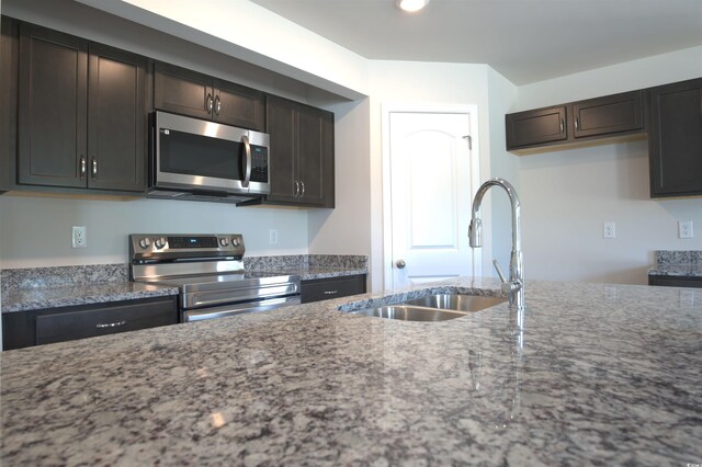 205 Kc Ln, Aynor, SC 29511 - kitchen featuring stainless steel appliances, light stone counters, dark brown cabinetry, and recessed lighting