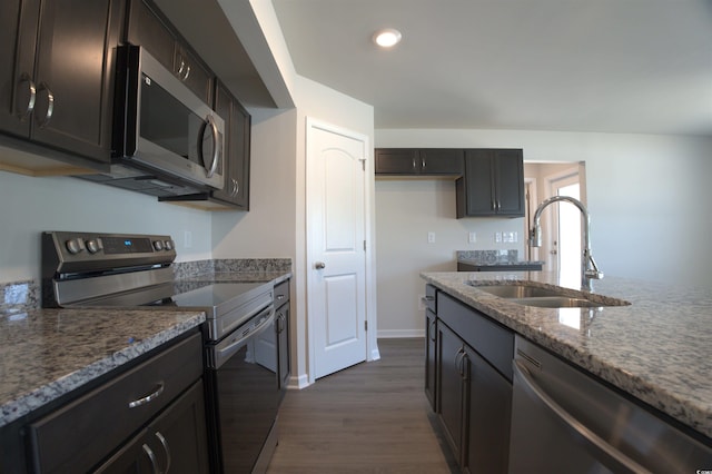 205 Kc Ln, Aynor, SC 29511 - kitchen with stainless steel appliances, dark wood finished floors, light stone counters, recessed lighting, and dark brown cabinets
