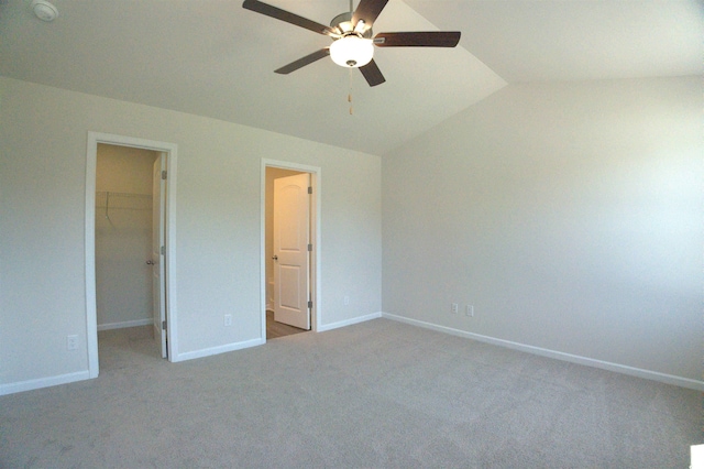 205 Kc Ln, Aynor, SC 29511 - unfurnished bedroom featuring a walk in closet, vaulted ceiling, carpet floors, and a ceiling fan