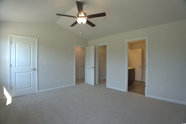 205 Kc Ln, Aynor, SC 29511 - unfurnished bedroom featuring light colored carpet, vaulted ceiling, ensuite bathroom, a spacious closet, and ceiling fan