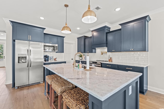 304 29th Ave N, North Myrtle Beach, SC 29582 - kitchen with appliances with stainless steel finishes, light stone countertops, a kitchen bar, light wood-style flooring, and hanging light fixtures
