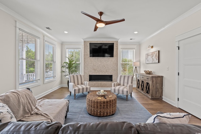 304 29th Ave N, North Myrtle Beach, SC 29582 - living room featuring ornamental molding, wood finished floors, ceiling fan, a fireplace, and recessed lighting