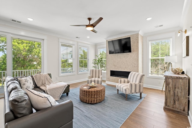 304 29th Ave N, North Myrtle Beach, SC 29582 - living area featuring crown molding, a ceiling fan, a fireplace, wood finished floors, and recessed lighting