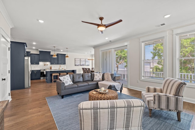 304 29th Ave N, North Myrtle Beach, SC 29582 - living area with ceiling fan, dark wood finished floors, crown molding, recessed lighting, and a chandelier