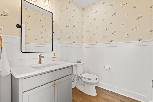 304 29th Ave N, North Myrtle Beach, SC 29582 - bathroom featuring wood finished floors, a decorative wall, vanity, and a wainscoted wall