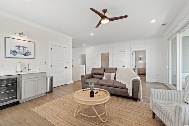 304 29th Ave N, North Myrtle Beach, SC 29582 - living room featuring wine cooler, wet bar, light wood finished floors, a ceiling fan, and recessed lighting