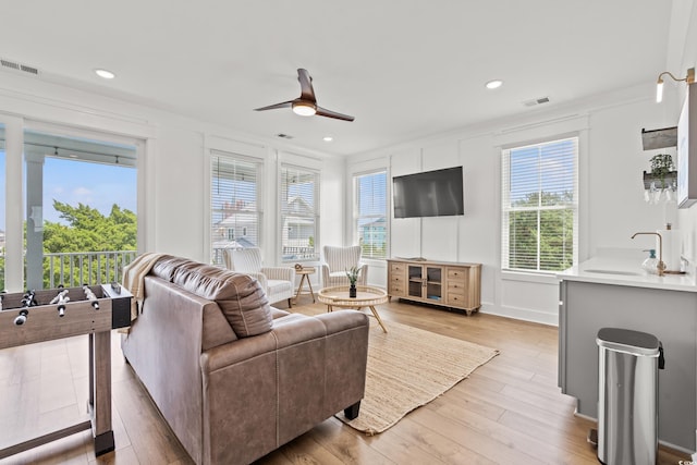 304 29th Ave N, North Myrtle Beach, SC 29582 - living room with ceiling fan, plenty of natural light, light wood-type flooring, recessed lighting, and ornamental molding