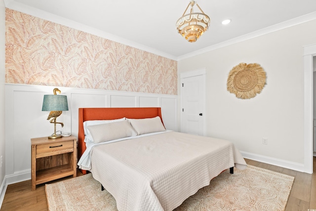 304 29th Ave N, North Myrtle Beach, SC 29582 - bedroom with wainscoting, wood finished floors, and ornamental molding