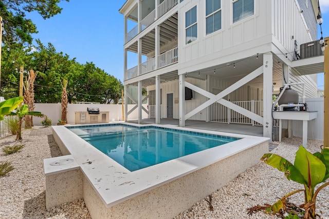304 29th Ave N, North Myrtle Beach, SC 29582 - view of swimming pool with a fenced backyard, a patio, and exterior kitchen