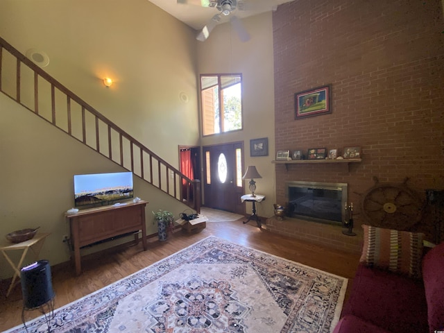 2232 Franklin Cir, Little River, SC 29566 - living area with a high ceiling, wood finished floors, stairway, ceiling fan, and a fireplace
