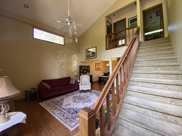 2232 Franklin Cir, Little River, SC 29566 - living area with high vaulted ceiling, ceiling fan, wood finished floors, and stairway