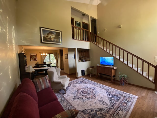 2232 Franklin Cir, Little River, SC 29566 - living room with a chandelier, a towering ceiling, wood finished floors, and stairway