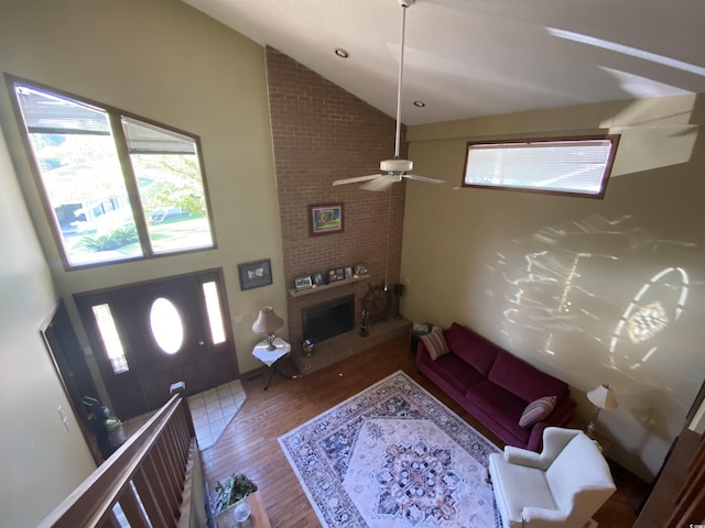 2232 Franklin Cir, Little River, SC 29566 - living room featuring wood finished floors, high vaulted ceiling, a brick fireplace, and ceiling fan