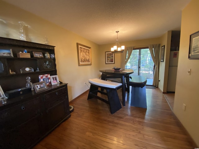 2232 Franklin Cir, Little River, SC 29566 - dining space featuring wood finished floors, a chandelier, and a textured ceiling