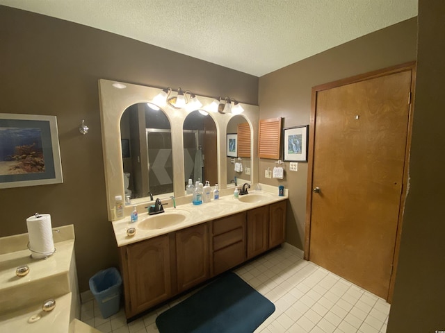 2232 Franklin Cir, Little River, SC 29566 - full bathroom featuring tile patterned floors, double vanity, and a textured ceiling