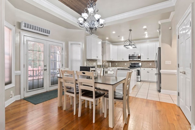 1504 27th Ave N, North Myrtle Beach, SC 29582 - dining space featuring crown molding, light wood-type flooring, french doors, a chandelier, and recessed lighting