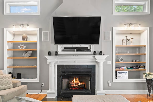 1504 27th Ave N, North Myrtle Beach, SC 29582 - living room featuring a tiled fireplace and wood finished floors