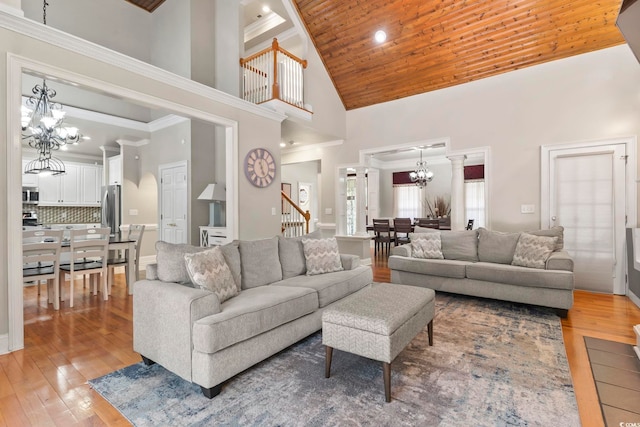 1504 27th Ave N, North Myrtle Beach, SC 29582 - living area featuring a chandelier, high vaulted ceiling, light wood-type flooring, wooden ceiling, and stairs