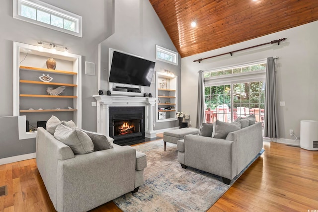 1504 27th Ave N, North Myrtle Beach, SC 29582 - living area featuring wood ceiling, high vaulted ceiling, built in features, a fireplace with flush hearth, and wood finished floors