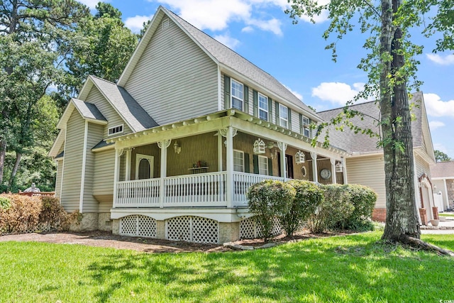 1504 27th Ave N, North Myrtle Beach, SC 29582 - view of front of house featuring covered porch, a front yard, and roof with shingles