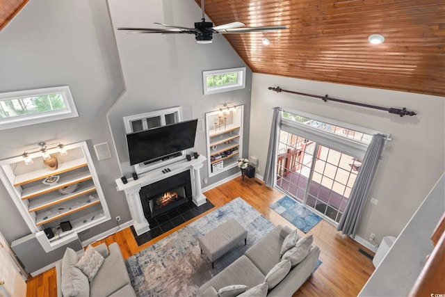 1504 27th Ave N, North Myrtle Beach, SC 29582 - living area with wood ceiling, a ceiling fan, high vaulted ceiling, wood finished floors, and a fireplace with flush hearth