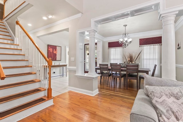1504 27th Ave N, North Myrtle Beach, SC 29582 - dining space with ornate columns, stairway, light wood-style floors, ornamental molding, and a chandelier