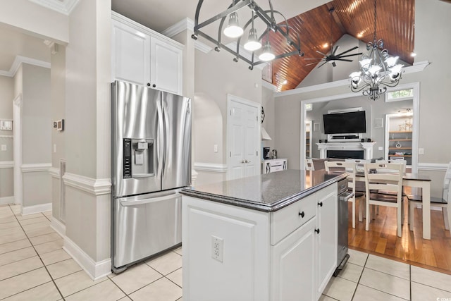1504 27th Ave N, North Myrtle Beach, SC 29582 - kitchen with stainless steel refrigerator with ice dispenser, light tile patterned floors, a kitchen island, white cabinetry, and a chandelier