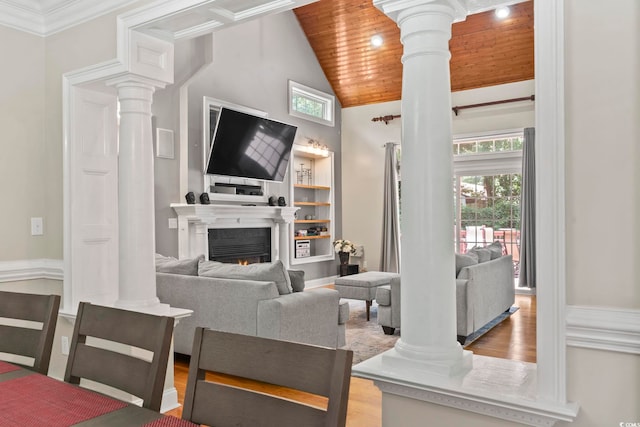 1504 27th Ave N, North Myrtle Beach, SC 29582 - living room featuring decorative columns, high vaulted ceiling, wood ceiling, a lit fireplace, and wood finished floors