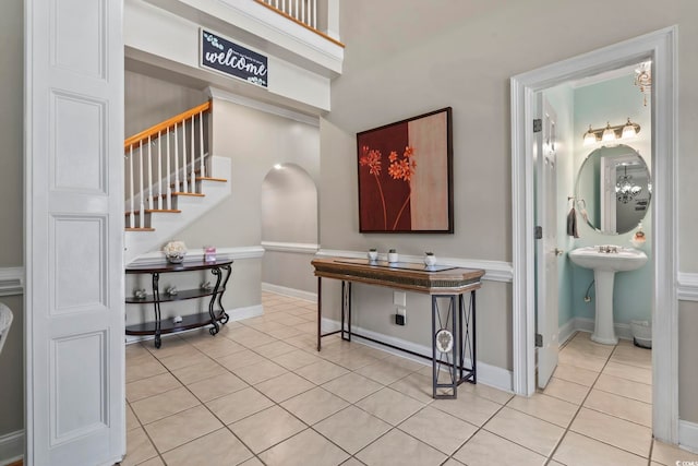 1504 27th Ave N, North Myrtle Beach, SC 29582 - hallway with light tile patterned floors, stairs, and arched walkways