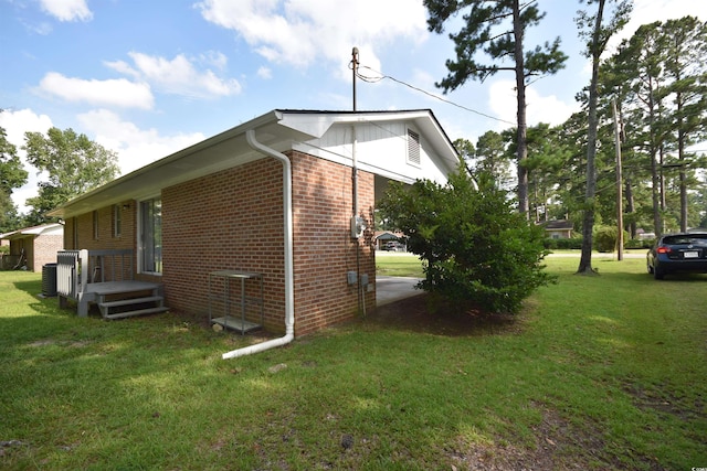 240 Yadkin Ave, Georgetown, SC 29440 - view of side of home with brick siding and a yard
