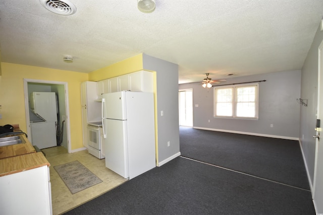 240 Yadkin Ave, Georgetown, SC 29440 - kitchen featuring white appliances, a ceiling fan, white cabinetry, a textured ceiling, and light carpet