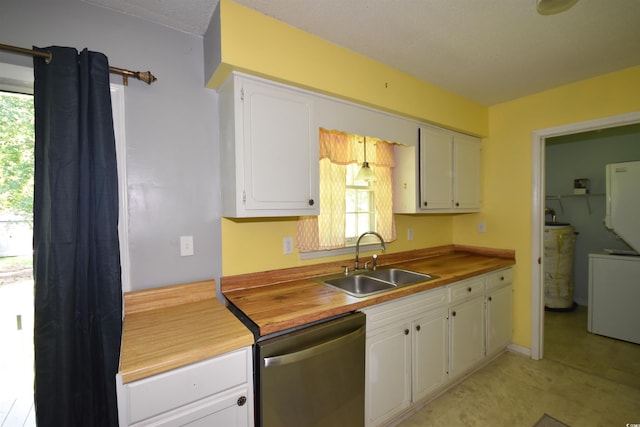 240 Yadkin Ave, Georgetown, SC 29440 - kitchen with stainless steel dishwasher, butcher block countertops, white cabinets, and independent washer and dryer