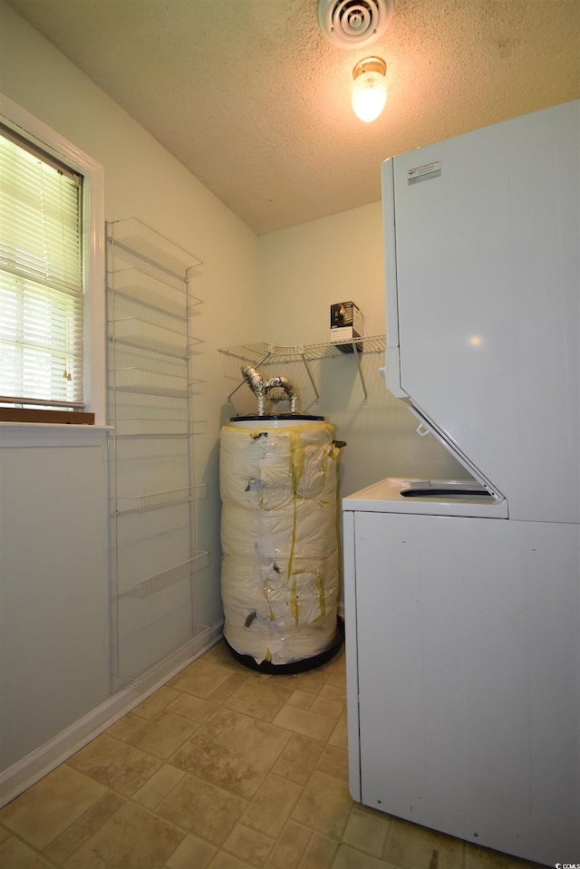 240 Yadkin Ave, Georgetown, SC 29440 - laundry room with water heater and a textured ceiling