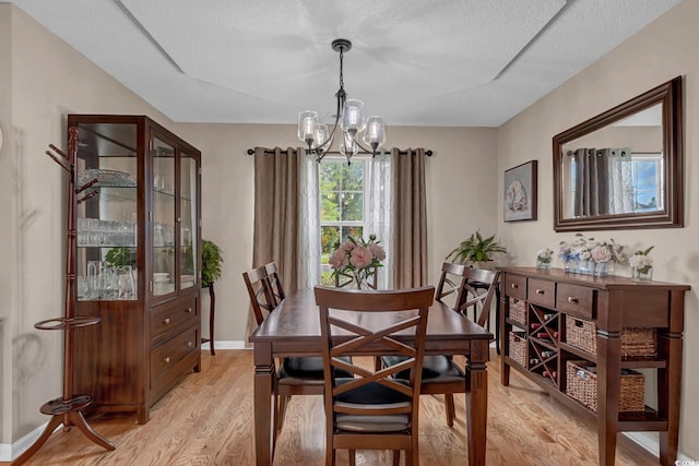 3922 Glenmere Dr, Myrtle Beach, SC 29588 - dining space featuring light wood finished floors, a chandelier, and a textured ceiling