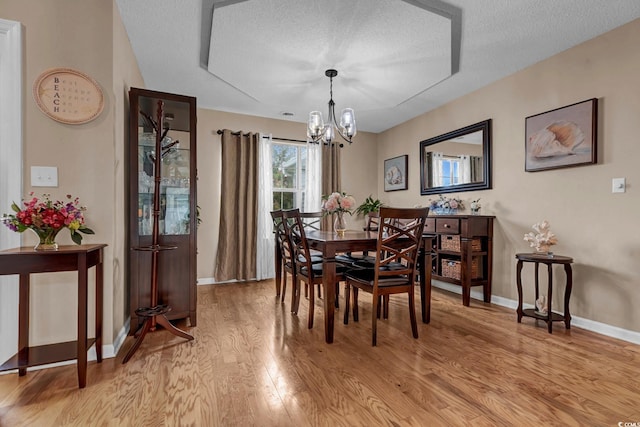 3922 Glenmere Dr, Myrtle Beach, SC 29588 - dining area featuring light wood-type flooring, a chandelier, and a textured ceiling