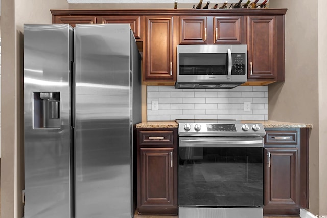 3922 Glenmere Dr, Myrtle Beach, SC 29588 - kitchen featuring stainless steel appliances, backsplash, and light stone counters