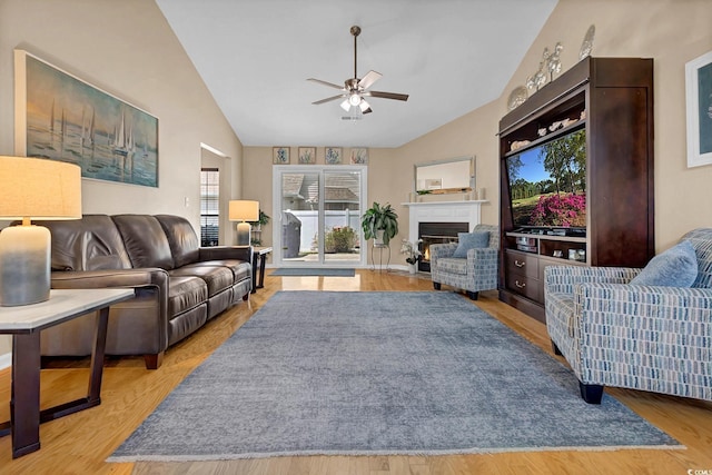3922 Glenmere Dr, Myrtle Beach, SC 29588 - living room featuring lofted ceiling, ceiling fan, a fireplace with flush hearth, and wood finished floors