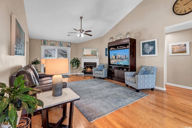 3922 Glenmere Dr, Myrtle Beach, SC 29588 - living room with ceiling fan, vaulted ceiling, a lit fireplace, and light wood-style floors