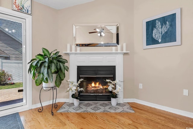 3922 Glenmere Dr, Myrtle Beach, SC 29588 - detailed view of wood finished floors, a fireplace with flush hearth, and a ceiling fan