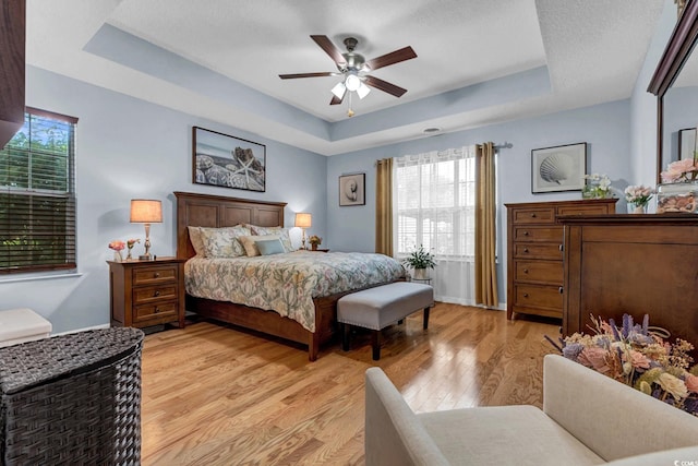 3922 Glenmere Dr, Myrtle Beach, SC 29588 - bedroom featuring a raised ceiling, light wood finished floors, and a ceiling fan