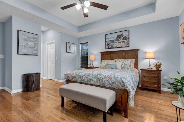 3922 Glenmere Dr, Myrtle Beach, SC 29588 - bedroom with light wood-type flooring, a ceiling fan, and a tray ceiling