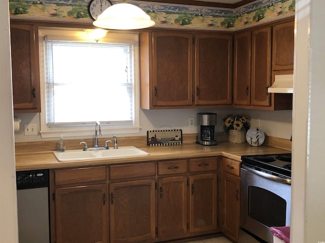 910 Perrin Dr, North Myrtle Beach, SC 29582 - kitchen with stainless steel appliances, custom exhaust hood, light countertops, and brown cabinets