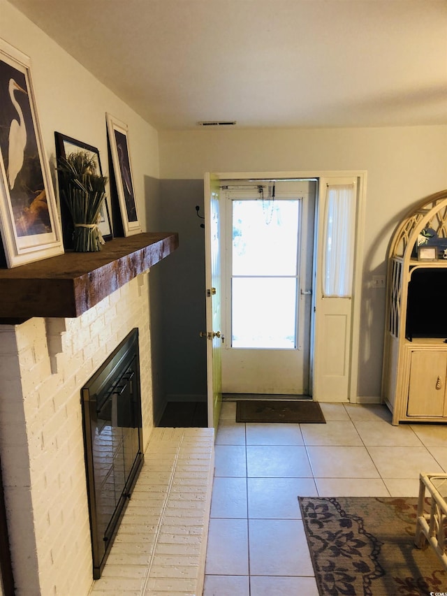 910 Perrin Dr, North Myrtle Beach, SC 29582 - entrance foyer featuring light tile patterned floors and a fireplace