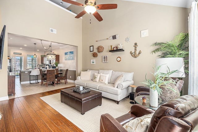 6014 Catalina Dr Unit 413, North Myrtle Beach, SC 29582 - living room featuring light wood-style flooring, a ceiling fan, a towering ceiling, a chandelier, and recessed lighting