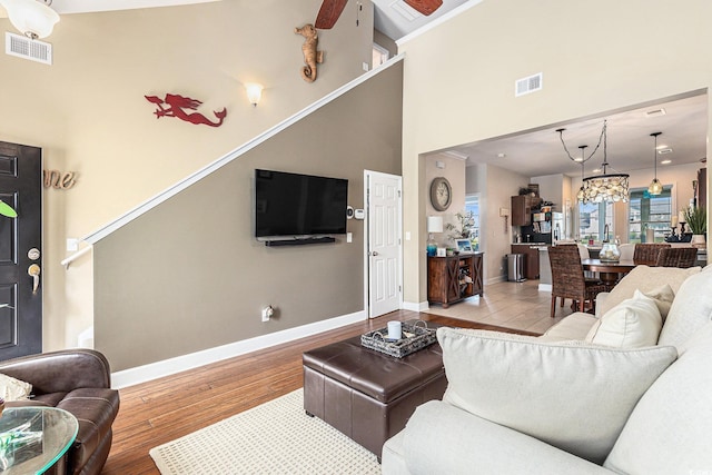 6014 Catalina Dr Unit 413, North Myrtle Beach, SC 29582 - living area featuring wood finished floors, a high ceiling, and a chandelier