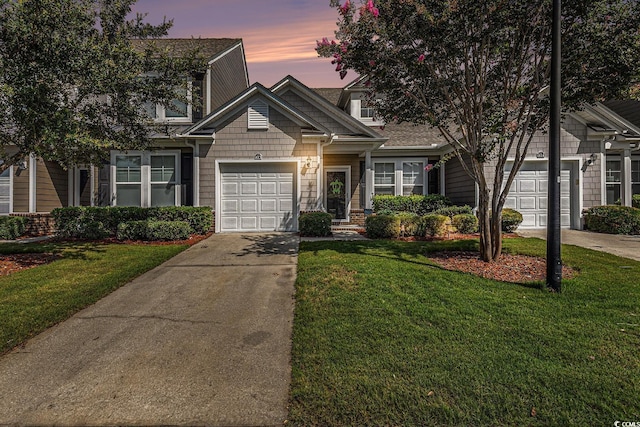 6014 Catalina Dr Unit 413, North Myrtle Beach, SC 29582 - view of front facade with driveway, an attached garage, and a front lawn
